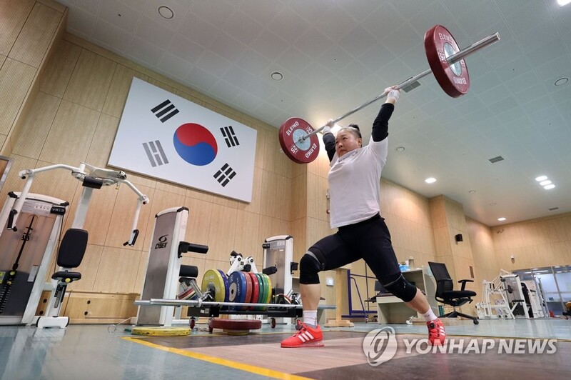 Ever the optimist, weightlifter pursues Olympic medal in new weight class