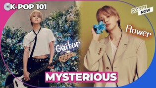 Guitar wielding BTS Jimin strikes a pose surrounded by flowers