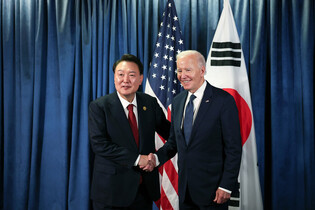 Yoon shakes hands with Biden