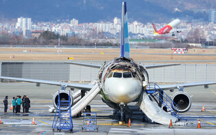 Fire-damaged airplane at Gimhae Int'l Airport