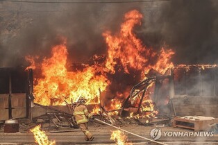 Fire response level raised to highest as wildfires spread