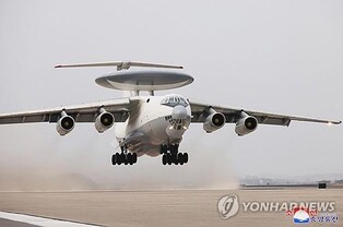 (LEAD) N.K.'s Kim boards airborne early warning plane, oversees AI-powered suicide drone test