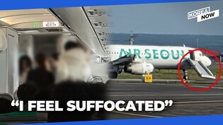 Passenger opens door of airline jet getting ready for takeoff at Jeju Int'l