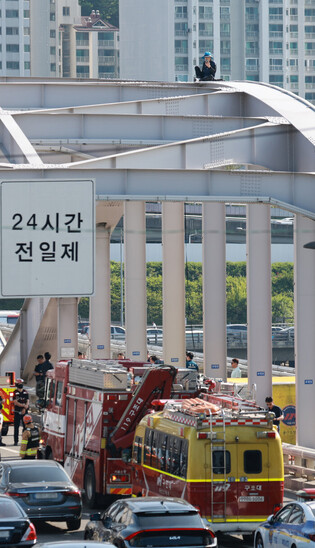 Protestor atop bridge arch