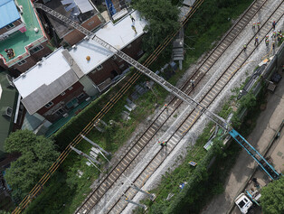 Ladder truck collapses over railway tracks in Seoul