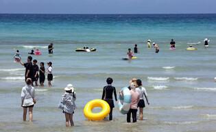 Beachgoers at Jeju's Hamdeok