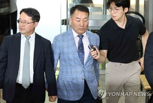 (LEAD) Ex-Marine chief appears for arrest warrant hearing