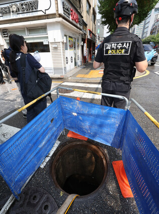 Man dies after being swept away inside manhole