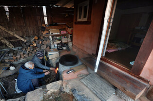 Wood-burning stove in traditional heating system