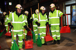 Prime minister sweeps street