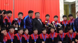 N. Korea's Kim holds photo session with female footballers