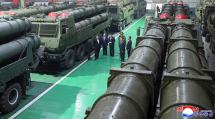 N.K. leader inspects factory producing multiple rocket launchers