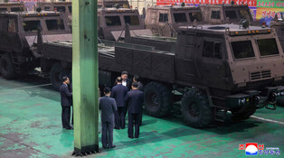 N.K. leader inspects factory producing multiple rocket launchers